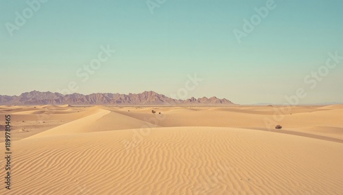Mountains and Sand Dunes Stretch Across the Desert Under a Clear Sky