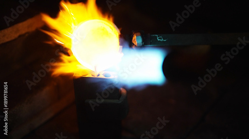 Quadro su tela Professional jeweler melting precious metal with gas torch.