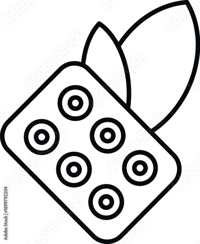 Herbal medicine pills in a blister pack with green leaves, symbolizing natural health supplements