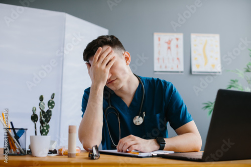 Fotografija Stressed doctor feeling burnout in office
