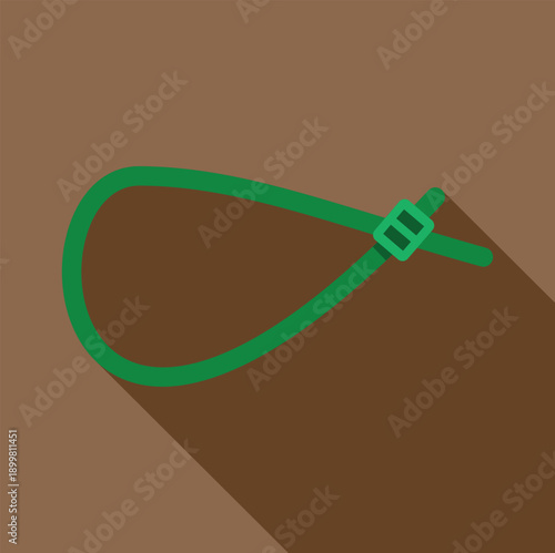 Green plastic cable tie providing a secure fastening solution with a long shadow