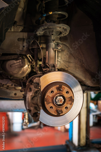 Car brake disk and caliper during automotive service