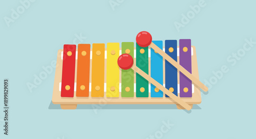 Colorful xylophone with mallets on a blue background.