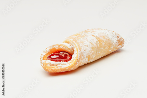 Closeup of a Kiffle Filled with Raspberry Jam on a White Background