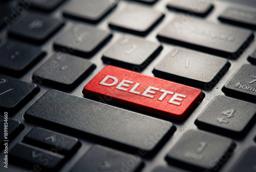 Red delete button on black computer keyboard closeup