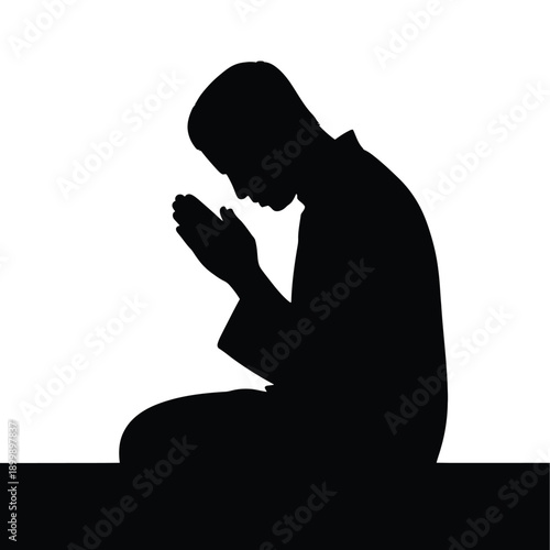 Silhouette of a person in prayer head bowed in reverence