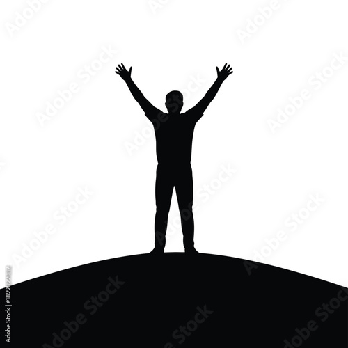 Silhouette of a person with arms raised standing on a hilltop