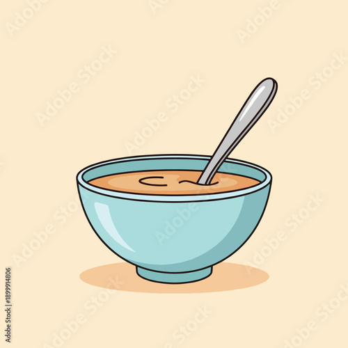 A bowl of soup with spoon.