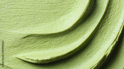 Fresh mixture of green paste spread on a surface at a kitchen in the afternoon