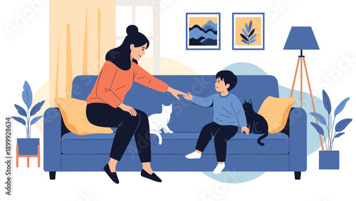 Loving mother and her young son relaxing on a comfortable blue sofa while playing with their two pet cats at home.