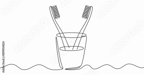 Two toothbrushes standing upright in a glass of water next to a wavy line.