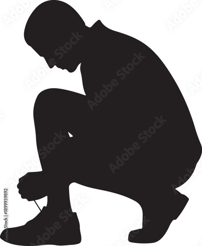 Silhouette of a person tying shoelaces crouching
