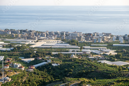 Wallpaper Mural Expansive View of Coastal Town With Greenhouses and Urban Development During Sunset Torontodigital.ca