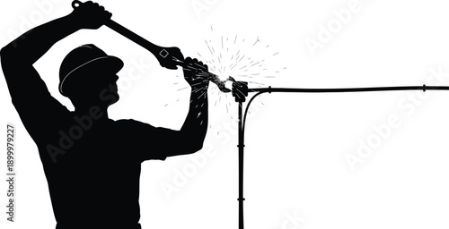 Silhouette of worker welding metal pipe with sparks flying