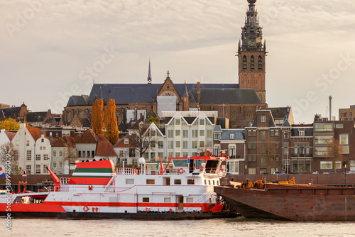 Cargo tugboat passing the Dutch city Nijmegen on the river Waal
