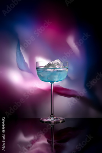 Blue ice cocktail on a colored abstract background