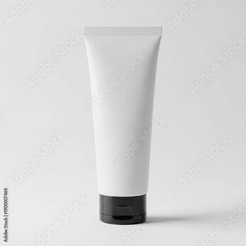 A tube of white cream with a black cap standing upright against a white background.