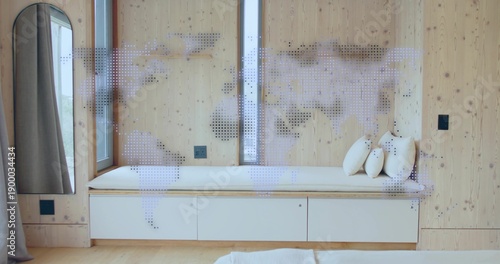 Showing built-in bench with white cushion and three round pillows under narrow window, dotted map