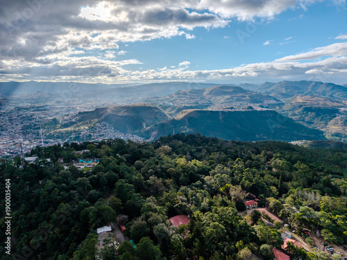 Beautiful aerial view of the city of Tegucigalpa and Comayaguela seen from surrounding mountains, urban valley and city skyline framed by dramatic hills in Honduras