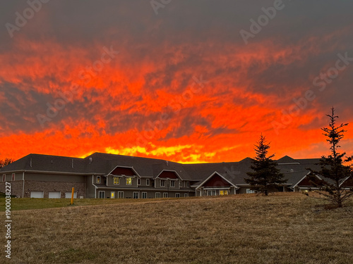 Dramatic fiery sunset over suburban buildings