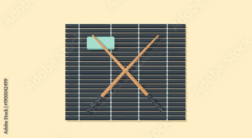 Crossed wooden chopsticks rest on a dark bamboo mat with a light green rectangular piece