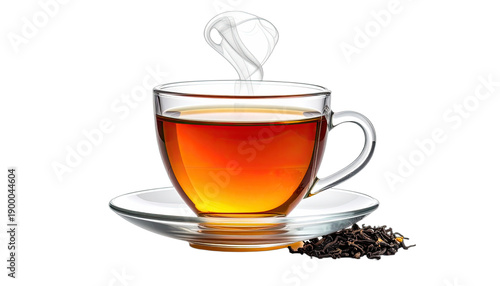 A clear glass cup of hot amber tea steams above a saucer with dry tea leaves nearby against a black background.