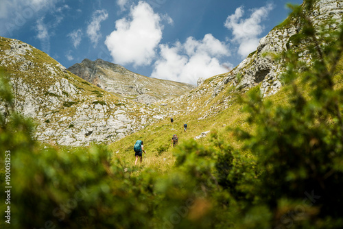 Hiker in a mountain landscape with blue sky