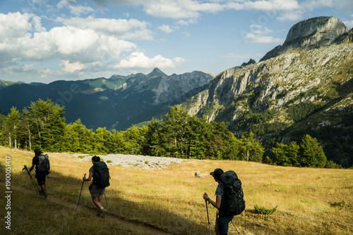 Two hikers on the trail with mountain views horizon