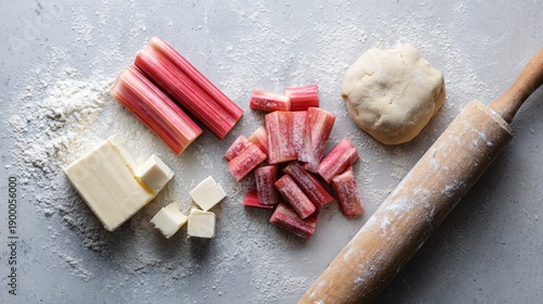 Wallpaper Mural Overhead flat lay of rhubarb galette ingredients on pale stone surface, sliced rhubarb, raw pastry dough, sugar, butter cubes, rolling pin, editorial recipe preparation layout Torontodigital.ca