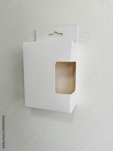 Side view of retail display box with hook and cut out side. minimal Side view white retail packaging with a hang tab and die-cut window