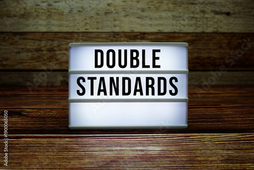 Photography Lightbox with text Double Standards on wooden background
