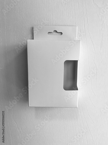 Front view black and white  retail display box with hook and cut out side. minimal white retail packaging with a hang tab and die-cut window