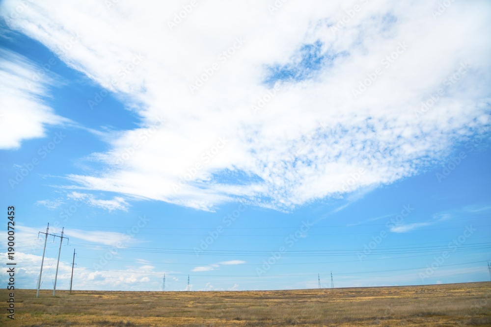Obraz premium Beautiful hilly landscape in the foreground with blue sky