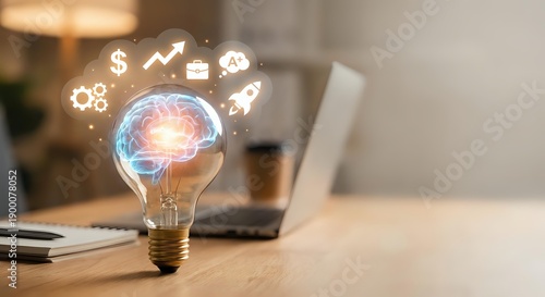 Creative lightbulb with glowing brain and business icons on wooden desk with laptop in modern office workspace for innovation and entrepreneurship concepts.