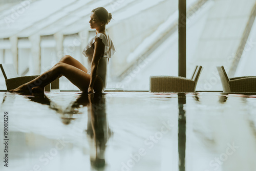 Woman sitting by the water ...