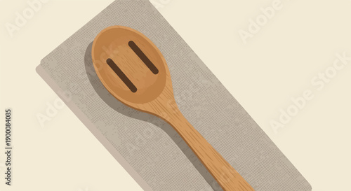 Overhead view of a wooden slotted spoon on a textured cloth