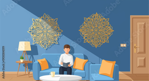 Man reading book on sofa in room with mandala art and lamp