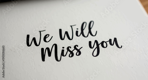 Handwritten script message "We Will Miss You" on a textured white background