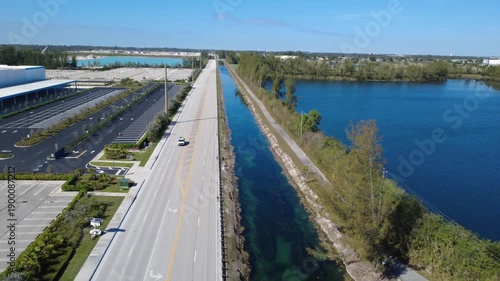 Wallpaper Mural Overhead aerial shot of an urban road beside water, ideal for concepts of transportation and city development. Torontodigital.ca