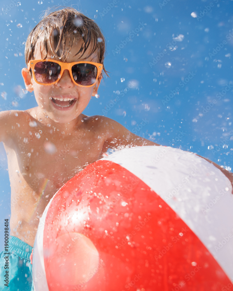 Fototapeta premium Happy child playing in waterpark. Kid having fun on summer vacation