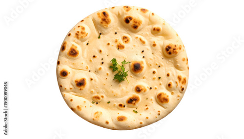 Overhead shot of round, baked flatbread, with brown spots, light color, and sprig