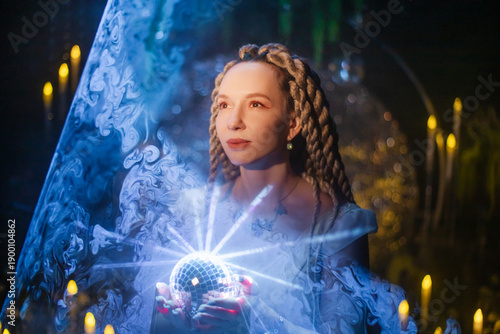 A sorceress in a shining portal, a mysterious girl in a golden dress in the rays of mystical light, framed by crystals and candles