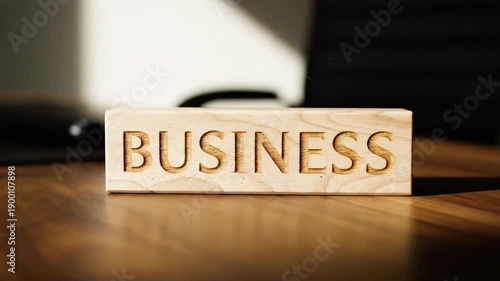 Wallpaper Mural Minimal office desk scene with a single wooden block reading BUSINESS Torontodigital.ca