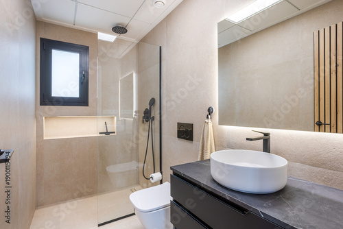 Contemporary bathroom with walk-in shower and modern black fixtures