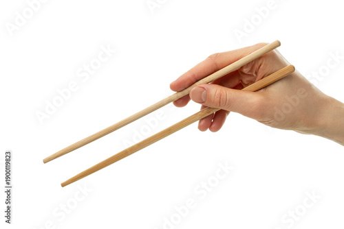 Hand holding wooden chopsticks isolated on white background