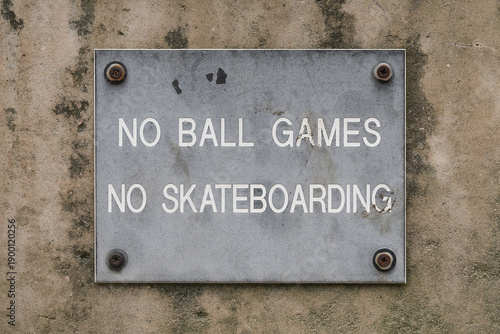 No Ball Games and No Skateboarding sign on urban concrete wall