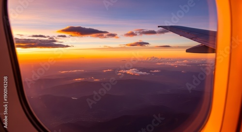 Stunning Sunset View from Airplane Window. Concept featuring airplane, window view, sunset, clouds, mountains.