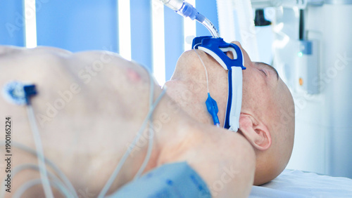 Fotografi Unconscious patient on life support in hospital intensive care unit