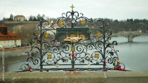 Bronze relief lectern of Saint John of Nepomuk on Charles bridge in Prague love locks Czech Republic most visited landmarks and tourist spot, symbol of the holy confession thrown drowned in the Vltava