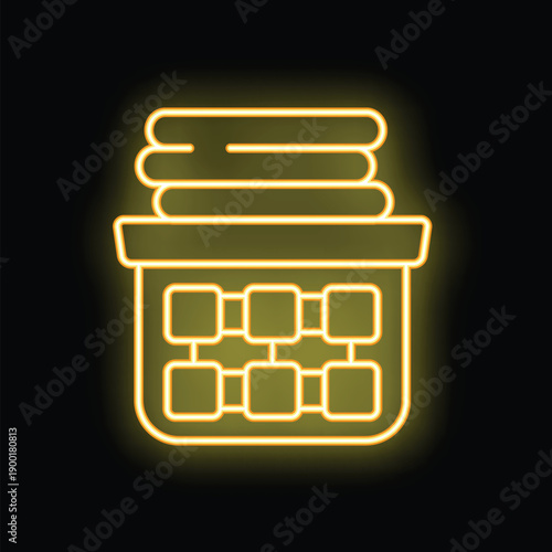 Neon glowing yellow icon of a laundry basket full of clothes, a concept of house chore